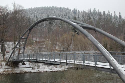 a bridge over a river with snow on the trees at Willa na Plażowej in Węgierska Górka