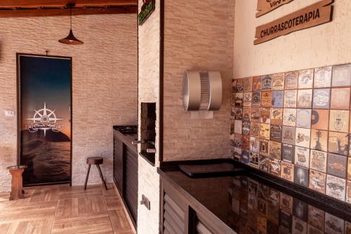 a room with a wall with tiles on it at Pousada Canto Azul Guarujá in Guarujá