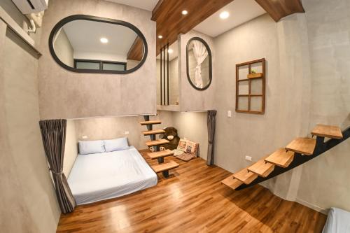 a tiny house with a bed and a staircase at Yonghua 196 in Tainan
