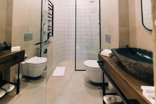 a bathroom with a sink and a toilet and a shower at Forest 1961 Boutique Hotel & Restaurant in Vanadzor