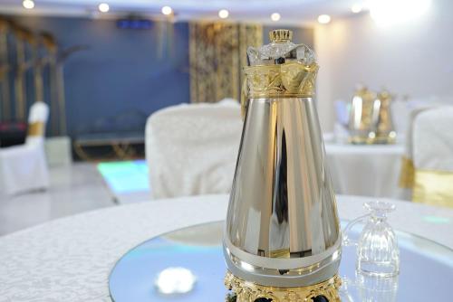 a silver and gold bottle on a table at شاليهات دي لا كروز in Makkah