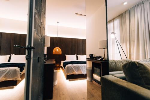 a hotel room with two beds and a mirror at Forest 1961 Boutique Hotel & Restaurant in Vanadzor