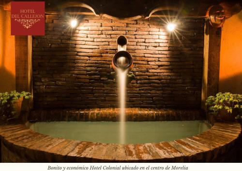 a water fountain in front of a brick wall at Hotel Morelia Callejón in Morelia