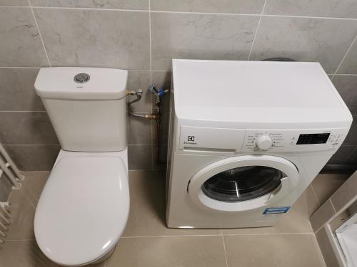 a bathroom with a toilet and a washing machine at Charming apartment Chambourcy in Chambourcy