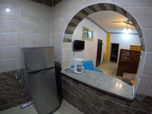uma cozinha com um balcão e um frigorífico num quarto em Cozy Apartment Freedom em Hurghada