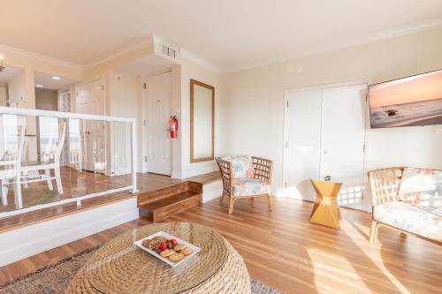 a living room with a table and chairs at La Mer Beachfront Resort in Cape May