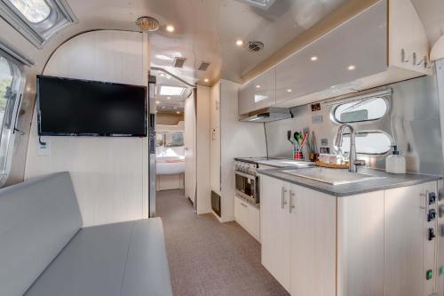 an rv kitchen with a sink and a tv at Taos Motor Lodge in Taos
