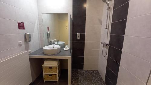 a bathroom with a sink and a mirror at Etesia in Feurs