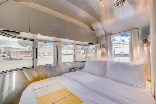 a bed in the back of a rv with windows at Taos Motor Lodge in Taos