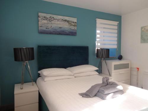 a bedroom with a bed with a towel on it at Dandy Lodge, Bowness-on-Solway in Bowness-on-Solway