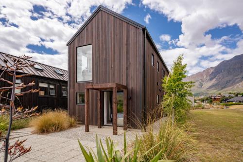 a wooden house with a large glass door at Stay Soudley @ Jack's in Frankton Wharf