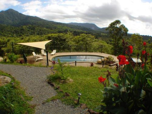 a house with a swimming pool in a garden at Coral Sea Views in Diwan