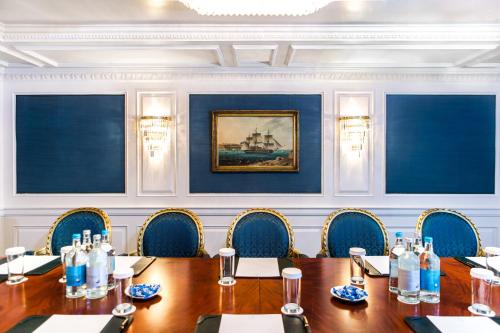 a conference room with a wooden table and chairs at Bentley London in London