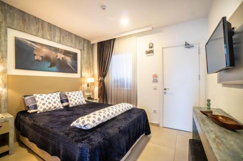 a bedroom with a bed and a flat screen tv at Seafront Flat with Breathtaking Sea View in Bodrum in Bodrum City