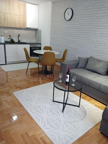 a living room with a couch and a table at Welcome Apartments in Niš