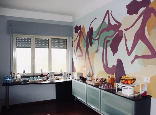 a kitchen with a counter with a painting on the wall at La scala del libro in Santo Stefano di Rogliano