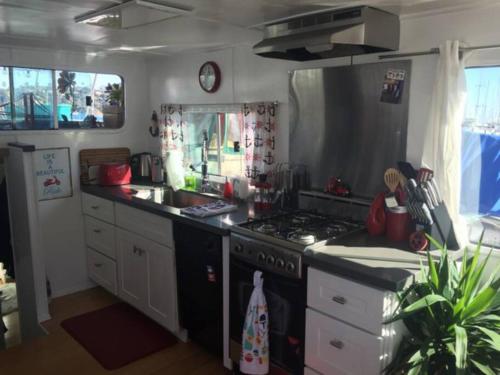a kitchen with a stove and a sink at Super cute, cozy houseboat in great location!!! in Sausalito