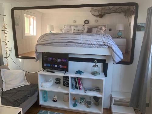a bedroom with a bed and a large mirror at Super cute, cozy houseboat in great location!!! in Sausalito