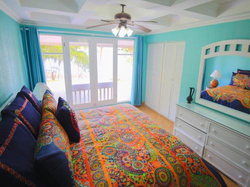 a bedroom with a bed and a ceiling fan at Bahia Pez Vela Resort in Ocotal
