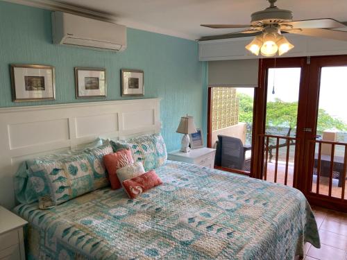 a bedroom with a bed and a ceiling fan at Bahia Pez Vela Resort in Ocotal