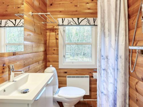 a bathroom with a toilet and a sink and a window at Seaside Escape in Laeso - By Traum Ferienwohnungen in Læsø