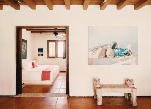a bedroom with a bed and a couch in a room at Las Palmas Luxury Villas in Zihuatanejo