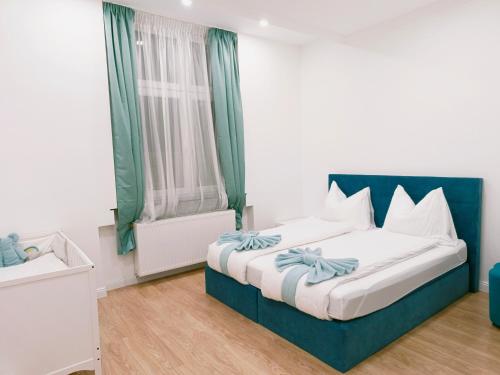a bedroom with a bed with a blue headboard at Ruyi holiday in Sopron