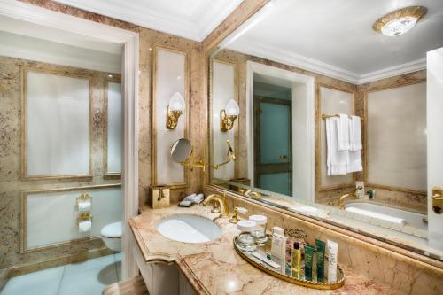 a bathroom with a sink and a large mirror at Bentley London in London