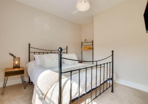 a bedroom with a bed and a side table at 4 Lambseth Street in Eye