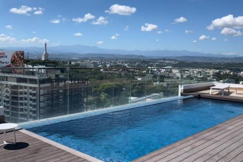 a swimming pool on the roof of a building at Soha Panorama B13 King Bed High Floor Balcony View in Santiago de los Caballeros