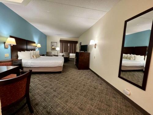 a hotel room with two beds and a mirror at Best Western Port Clinton in Port Clinton