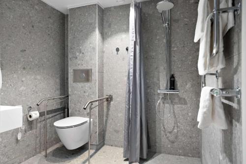 a bathroom with a shower with a toilet and a sink at Best Western Gustaf Froding Hotel & Konferens in Karlstad
