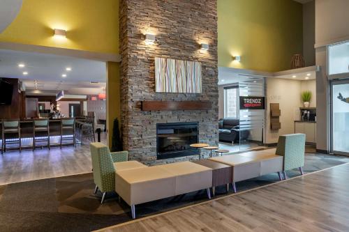 a lobby with a couch and a fireplace at Best Western Plus Dartmouth Hotel & Suites in Halifax