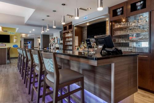 a bar with a row of chairs at a restaurant at Best Western Plus Dartmouth Hotel & Suites in Halifax