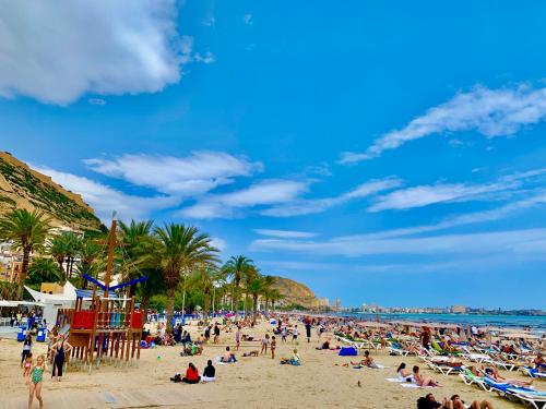 a crowd of people on a beach with the ocean at Apartment en Rambla in Alicante