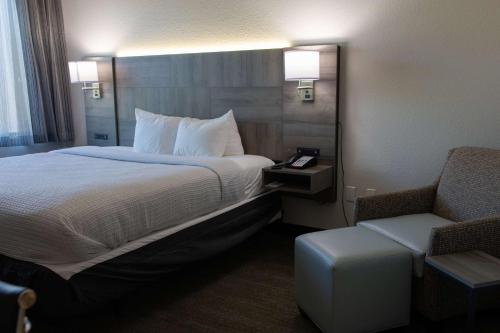 a hotel room with a bed and a chair at Best Western Plus Executive Residency Phoenix North Happy Valley in Phoenix
