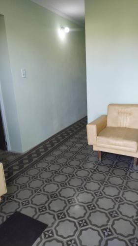 a living room with a couch and a floor at Don Oscar Alojamientos Dpto Lenna in San Justo