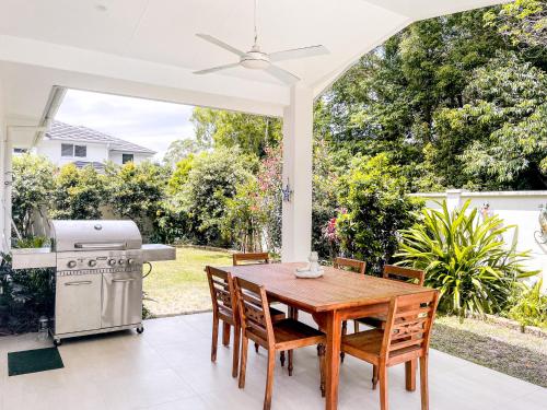 a patio with a table and chairs and a grill at Seadrift Byron in Byron Bay