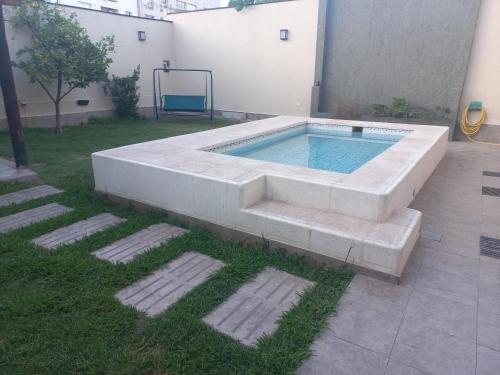 a swimming pool in the middle of a yard at 1670 House in Mendoza