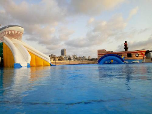 a water slide in the water with a person sitting on a bench at T3 A 2 PAS DE LA MER ,we accept 7 days reservation only and more in Ashdod