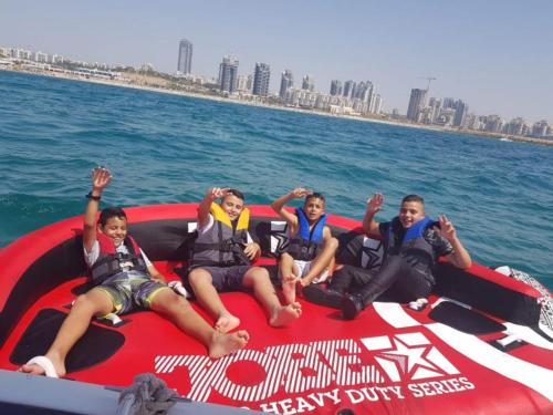 a group of people sitting on a boat in the water at T3 A 2 PAS DE LA MER ,we accept 7 days reservation only and more in Ashdod