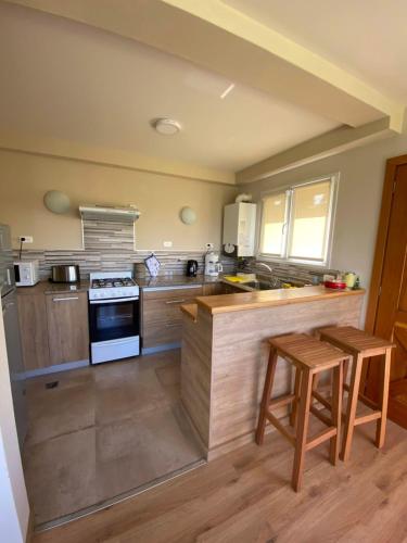 a kitchen with wooden counters and a stove top oven at Andalue in San Carlos de Bariloche