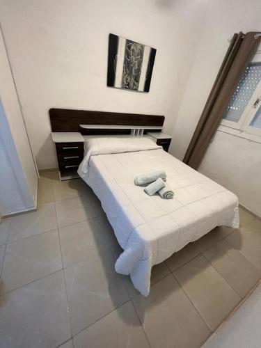 a bedroom with a bed with two towels on it at Gran Colonial Riviera in Piriápolis