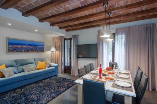 a living room with a table and a blue couch at Autèntic Eixample Barcelona in Barcelona