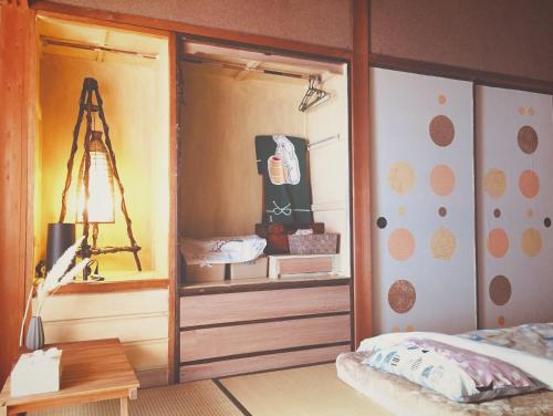 a bedroom with a closet with a bed in it at Ise Chitose in Ise