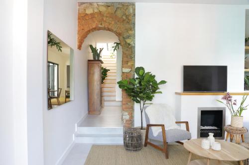 a living room with a fireplace and a tv at Waterkant House - 151 in Cape Town
