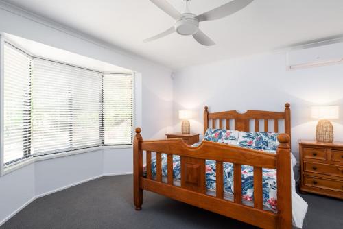 a bedroom with a bed and a ceiling fan at 13 Orania Court in Rainbow Beach