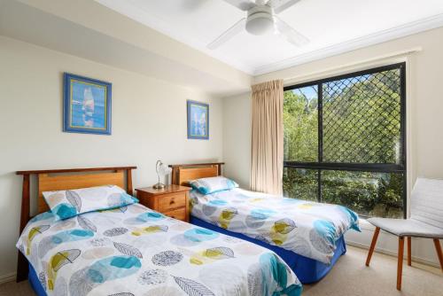 a bedroom with two beds and a window at Sharon Lee 2 in Rainbow Beach