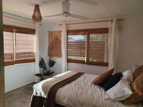 a bedroom with a bed and a ceiling fan at Surf N Earth in Rainbow Beach