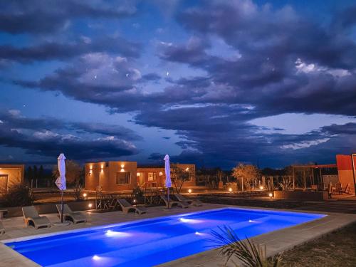 a swimming pool at night with a cloudy sky at Tres Cruces in Villa Unión